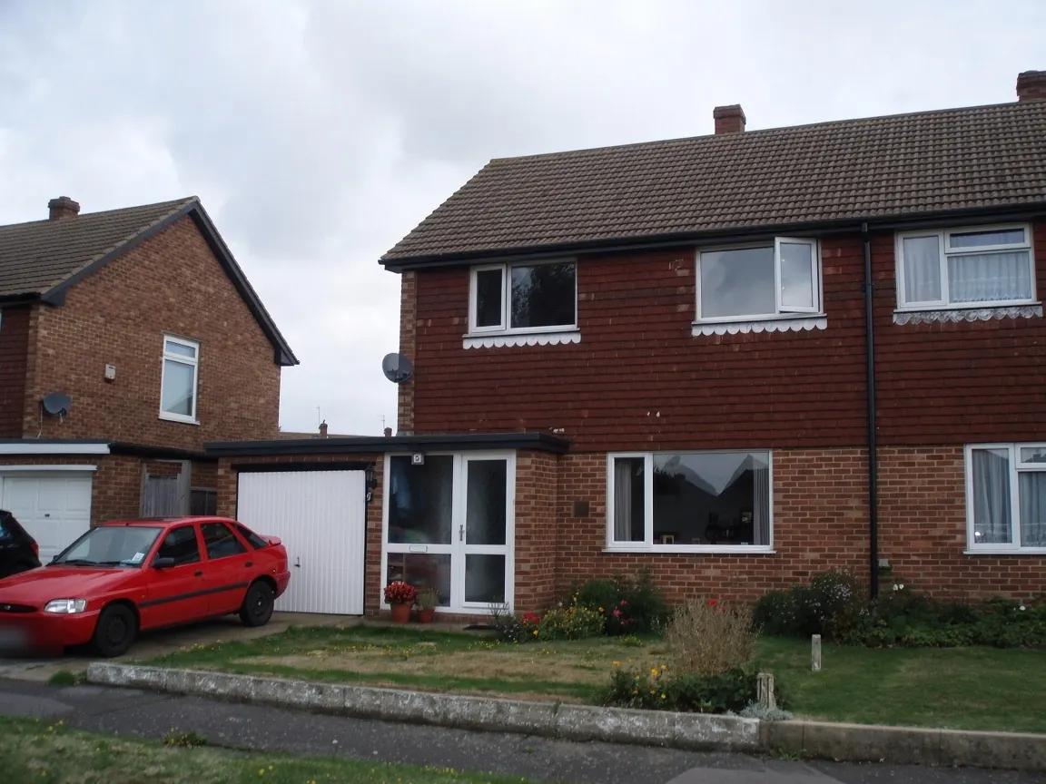 Semi-detached house with black uPVC fascias, bargeboards and gutters